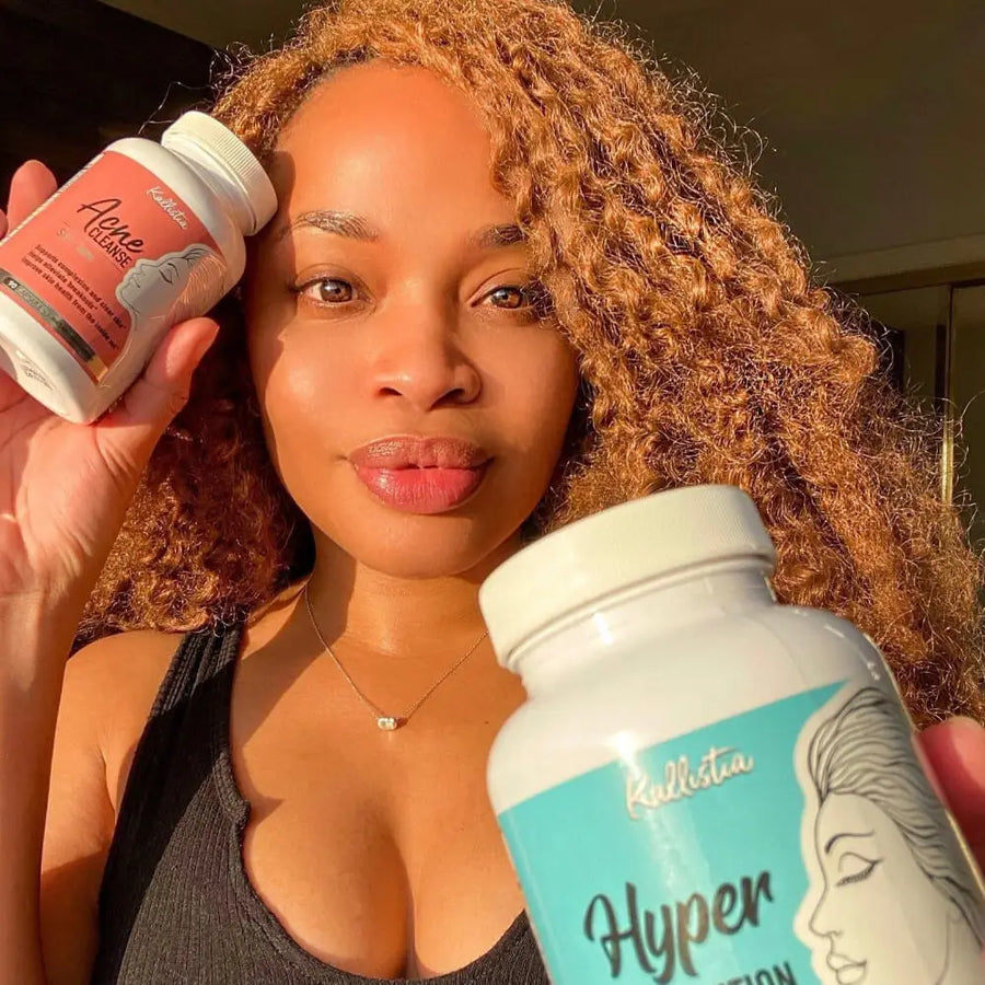 Woman holding two supplement bottles labeled 'Acne Cleanse' and 'Hyperpigmentation cleanse' in a close-up shot.